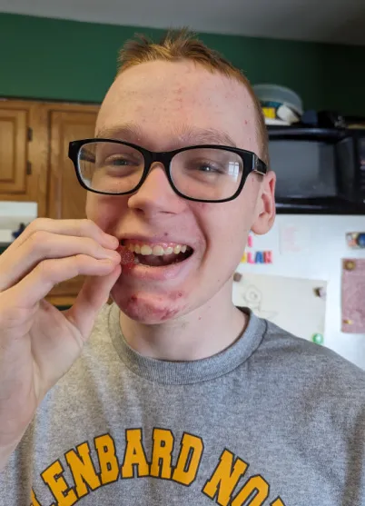 Katie's son eating a CBD gummy from Green Compass